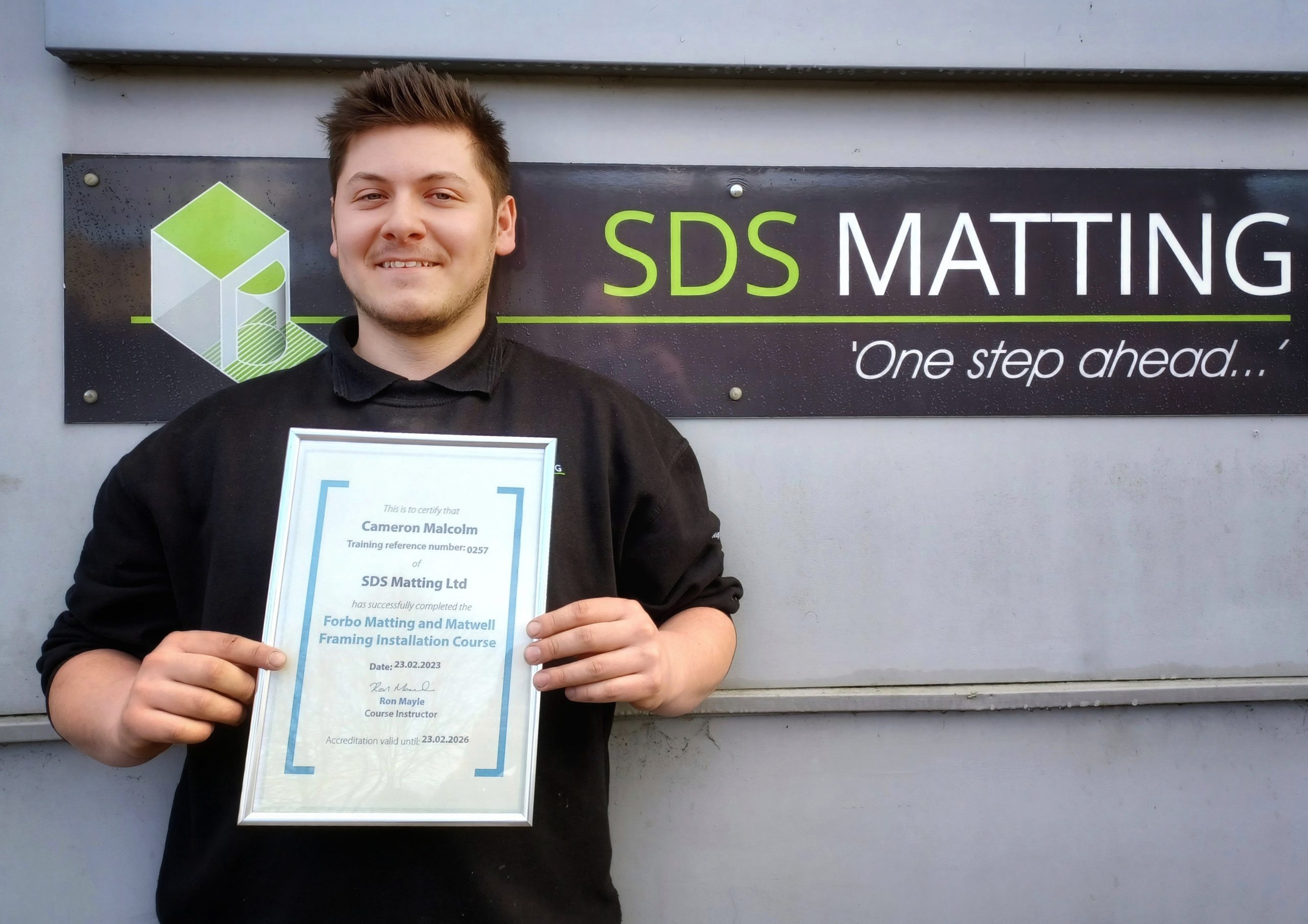 Cameron proudly displaying his Forbo training certificate